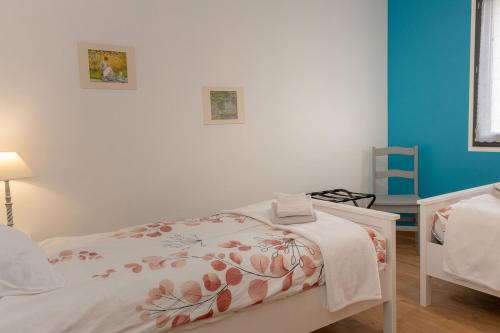 a bedroom with a bed with a blanket on it at Les Chaudannes in La Croix-de la Rochette