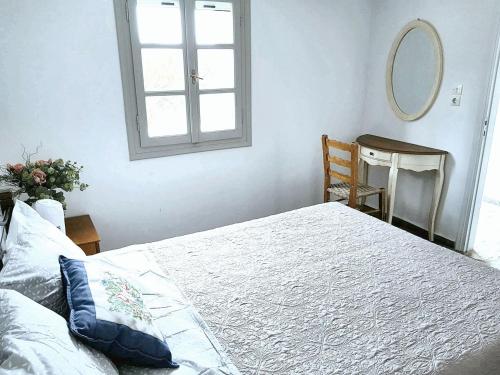 a bedroom with a large bed and a mirror at House with sea view in Porto Heli, fireplace and garden in Porto Heli