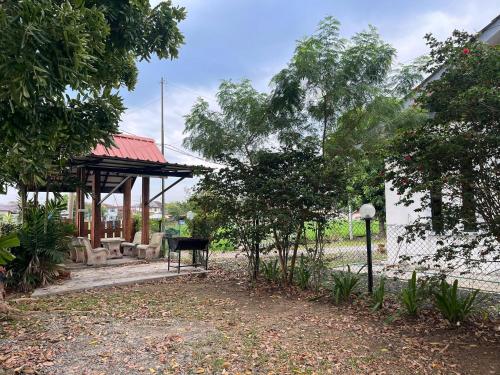 a park with a pavilion and a bench and trees at INAP PULAI SENTOSA in Alor Setar