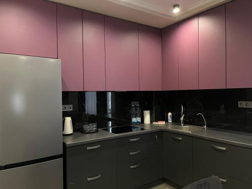 a kitchen with pink cabinets and a sink at "Гірський Континент" Hotel Restaurant & SPA in Yablunytsya