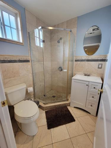 a bathroom with a shower and a toilet and a sink at 3 bedroom apartment by the MrC Hotel and 5 minutes to Rodeo Drive WiFi TV Patio walk to restaurants in Los Angeles