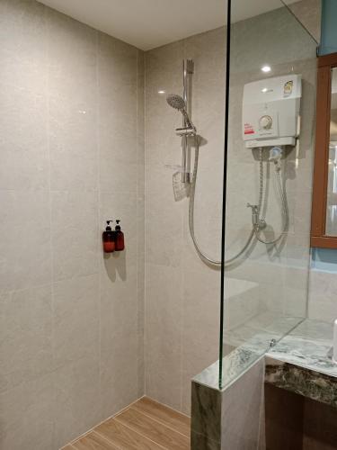 a shower stall in a bathroom with a shower at Eastique Hotel Koh Chang in Trat