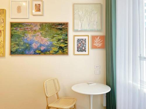 a table and a chair and some pictures on a wall at Studio 524- Stylish Urban Retreat on Central Queen Street in Auckland