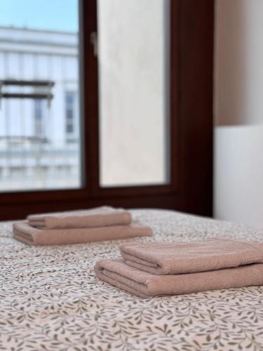 3 serviettes pliées assises au-dessus d'un lit dans l'établissement Modern old town studio - Balcony, Coffee, Wifi, à Vinohrady