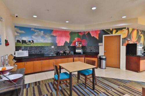 a large kitchen with a table and chairs at Comfort Inn & Suites Houston North - Spring in Houston