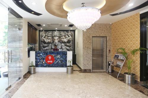 a lobby with a large painting on the wall at Collection O Pearl Blue in Tājganj
