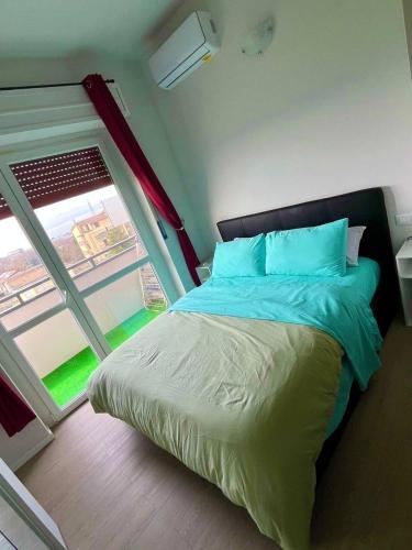 a bedroom with a large bed and a window at Gaelle Voghera apartment in Voghera