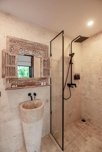 a bathroom with a sink and a shower at Sister Suites in Seminyak