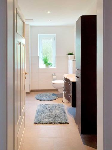 a bathroom with a toilet and a sink and a window at Grossenhain Ferien in Großenhain