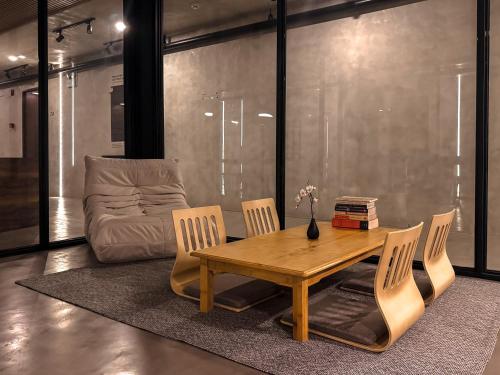 a living room with a table and chairs and a couch at Yamato Hostel in Manila