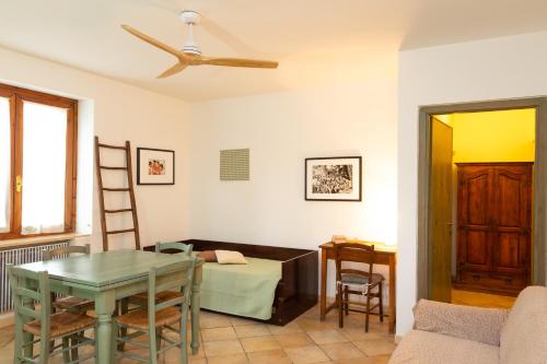 a living room with a table and a chair at Agriturismo La Facenda in Albinia