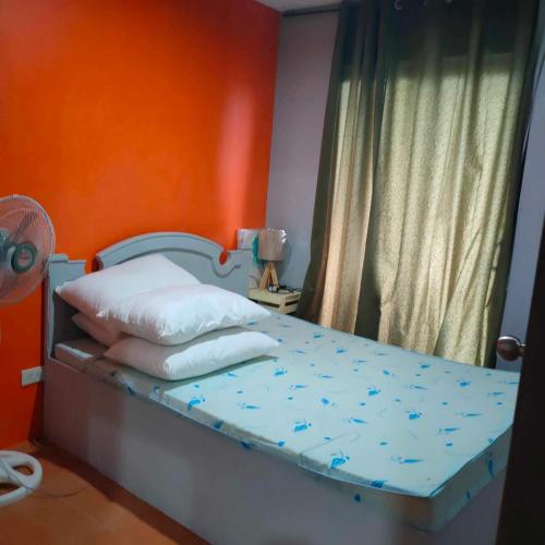 a bedroom with a bed with blue flowers on it at KLER Condo Resort Style at ONE Oasis in Cebu City