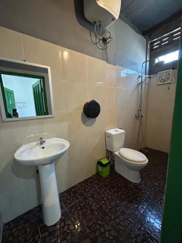 un bagno con lavandino e WC di Rock Backpackers Central Hostel a Vang Vieng