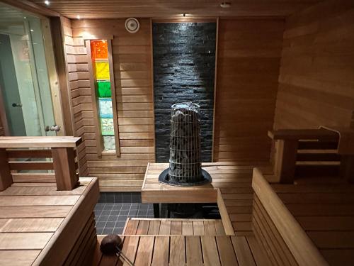 a sauna with a pillar in the center of the room at Luxury City Apartments, Downtown Loft House with Private Sauna in Rovaniemi