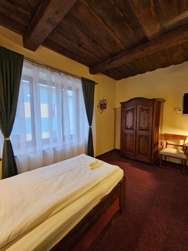 Postel nebo postele na pokoji v ubytování Hotel Galerie
