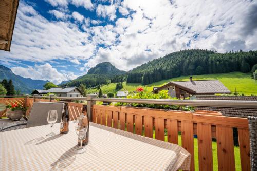 a table on a balcony with a view of mountains at Haus Friedrich in Gosau