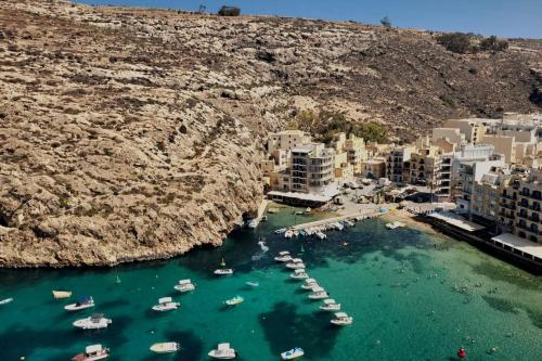an aerial view of a harbor with boats in the water at Gozo Xlendi Coastal Apartment with Stunning Sea View, Free Private Parking, AC & WiFi in Xlendi
