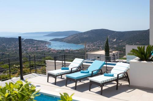 a balcony with chairs and a view of the ocean at Villa Lemon Tree in Vinišće