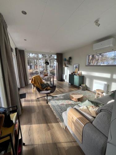a living room with a couch and a table at Villa Hutspot in Haarle