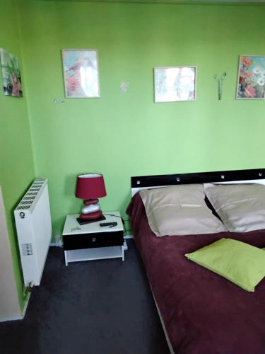 a bedroom with two beds and a lamp on a night stand at Chez Corinne in La Roche-Chalais