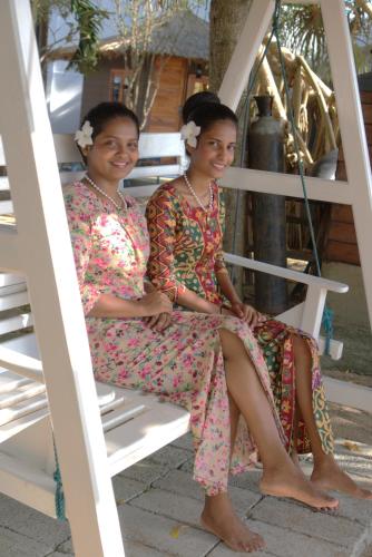 two young women sitting on a white bench at Tomorrowland Beach Villas in Tangalle