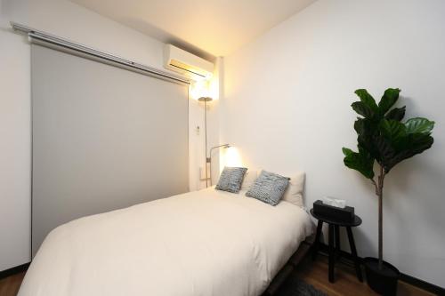 Una cama o camas en una habitación de Vivace湘南