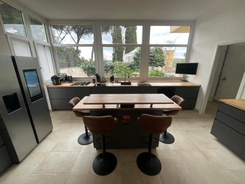 a kitchen with a table and chairs in a room at Relais Terrazza sul lago Castelgandolfo in Marino