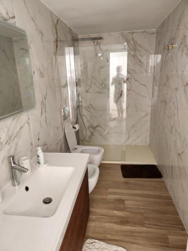 a bathroom with a sink and a toilet and a shower at Casa TONINO in Torre Vado