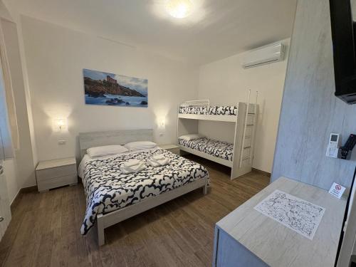 a small room with two beds and a bunk bed at Agriturismo Galeazzi in Marsiliana