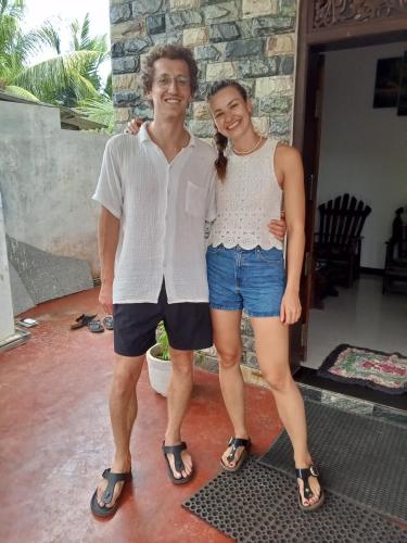 a man and a woman posing for a picture at Muru's Place in Dickwella