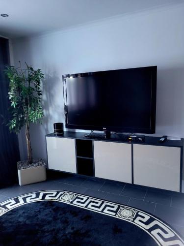 a living room with a large flat screen tv at Appartement Sabrina in Steinberg am Rofan