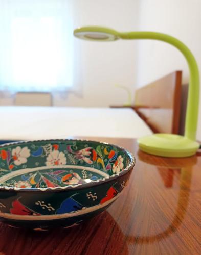 a bowl sitting on top of a wooden table at Apartma Vodrice in Slappe dʼIdria
