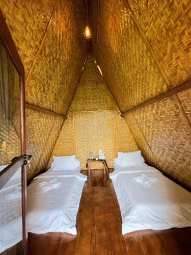 a room with two beds in a yurt at Kelimutu Paradiso Resort in Kelimutu