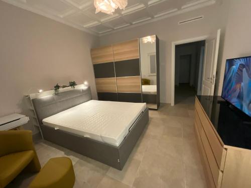 a bedroom with a bed and a television in it at Relais Terrazza sul lago Castelgandolfo in Marino
