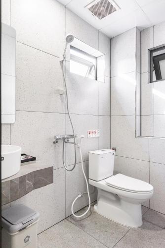 a bathroom with a shower with a toilet and a sink at GARE D'47 l 21 Lê Chân street l Đối diện Nhà hát lớn in Hai Phong