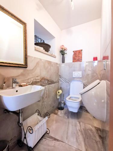 a bathroom with a white sink and a toilet at Geratičevo in Lovrenc na Pohorju