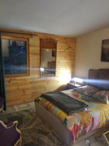 a bedroom with a bed and a lamp in a room at Libellule in Champclause