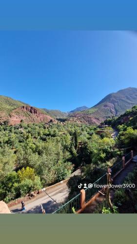 a person riding a bike on a road in the mountains at Villa Romancia Ourika Vallee in Marrakech