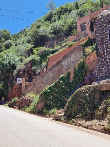 a hill with a building on the side of a road at Villa Romancia Ourika Vallee in Marrakech