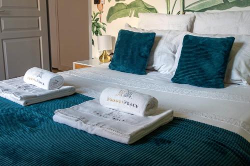 two towels are sitting on top of a bed at Le Baleschoux - PrestiPlace Collection in Tours