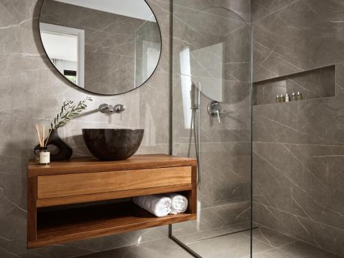 a bathroom with a sink and a mirror at Zakynthos Villa with Stunning Views in Agios Nikolaos