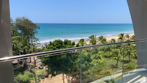 a balcony with a view of the beach and the ocean at Luxury penthouse , Nilaveli, Srilanka in Nilaveli