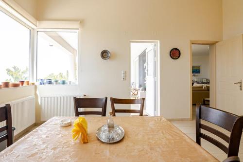 a dining room with a table and chairs at Villa Panorama in Makry Gialos