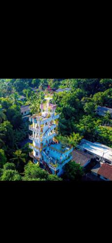 an aerial view of a tall building in a city at The Hotel Ujaliya in Rathgama