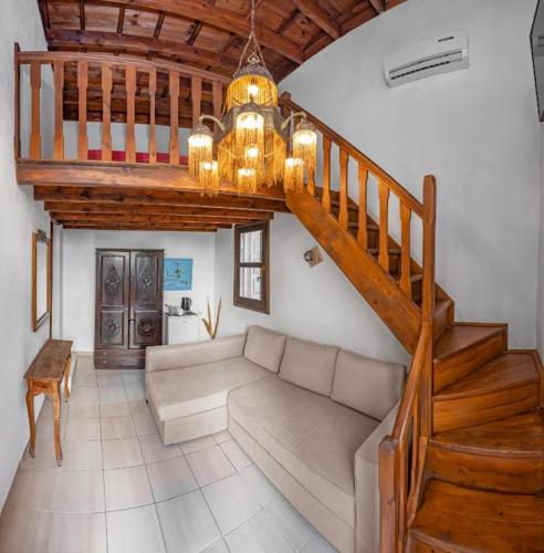 a living room with a couch and a staircase at Saint Michel Hotel in Rhodes Town