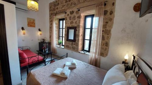 a room with a bed with two towels on a table at Saint Michel Hotel in Rhodes Town