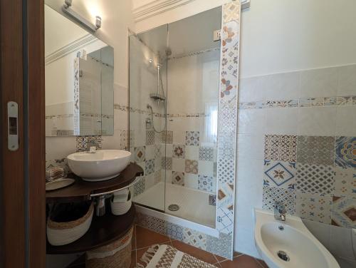 a bathroom with a sink and a shower and a toilet at Passo del Mattino in Locati