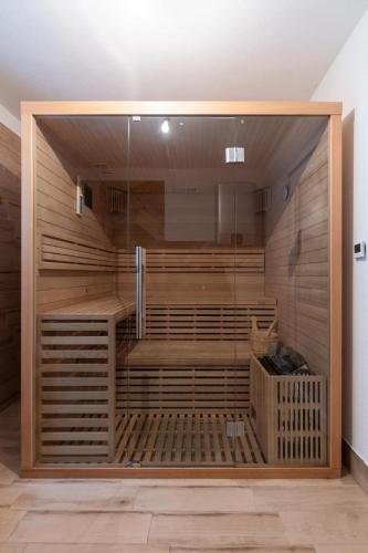 a sauna with wooden walls and a glass door at Casa Montana in Kopaonik