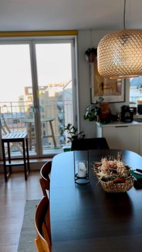 a dining room table with a basket of flowers on it at Penthouse: Copenhagen delight in Copenhagen