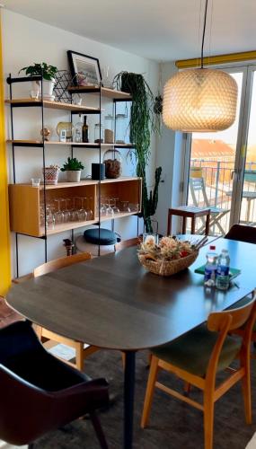 a dining room with a table and chairs and a shelf at Penthouse: Copenhagen delight in Copenhagen